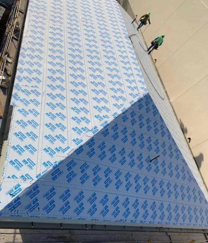 Professional roofers installing underlayment on a metal roof in Westmont